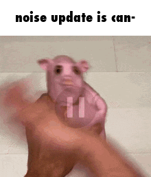 A Person Is Holding A Pink Pig In Their Hand And Says Noise Update Is Can . GIF