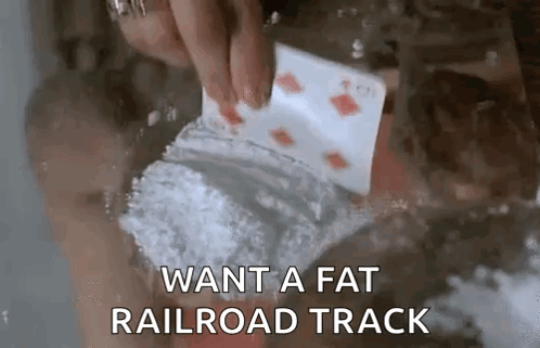 A Person Is Holding A Playing Card And A Bag Of Cocaine In Their Hand . GIF