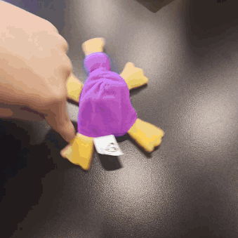 A Person Is Holding A Purple And Yellow Stuffed Animal With A Tag That Says Mcdonalds On It GIF