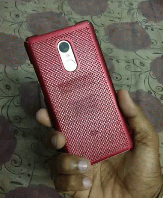 A Person Is Holding A Red Cell Phone In Their Right Hand GIF