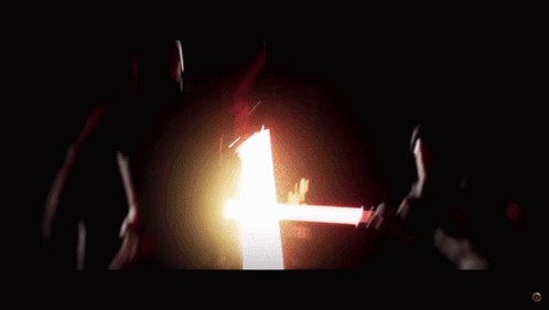 A Person Is Holding A Red Light Saber In Their Hand GIF