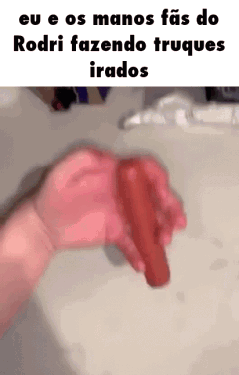 A Person Is Holding A Red Object In Their Hand In Front Of A Sink . GIF