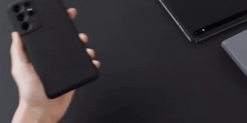 A Person Is Holding A Samsung Phone In Their Hand GIF