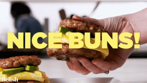 A Person Is Holding A Sandwich With The Words Nice Buns Behind Them GIF