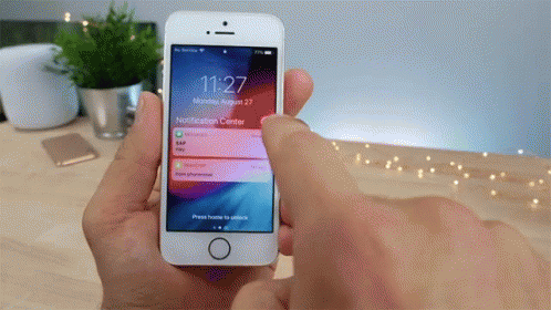 A Person Is Holding A Smart Phone In Their Hand And The Time Is 11:27 GIF