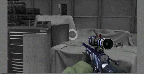 A Person Is Holding A Sniper Rifle In A Room With Boxes In The Background And A Sniper Scope On The Wall GIF