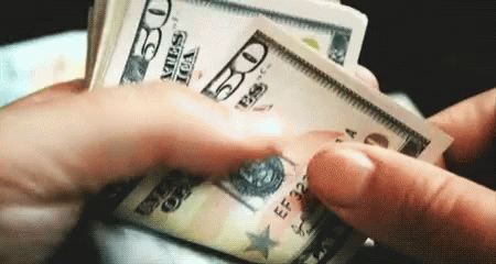 A Person Is Holding A Stack Of 50 Dollar Bills In Their Hands GIF
