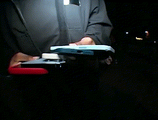 A Person Is Holding A Stapler And A Cell Phone GIF