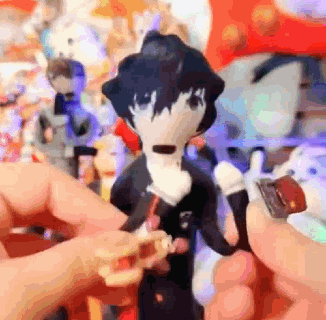 A Person Is Holding A Stuffed Animal In Their Hand In Front Of A Bunch Of Stuffed Animals . GIF