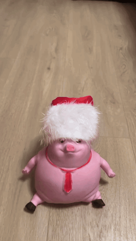 A Person Is Holding A Stuffed Animal On A Wooden Floor GIF