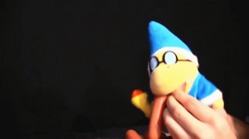 a person is holding a stuffed animal with a blue hat and glasses on it .