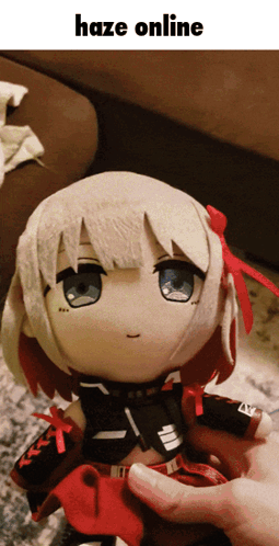 A Person Is Holding A Stuffed Doll That Says Haze Online On It GIF