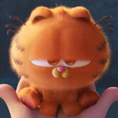 A Person Is Holding A Stuffed Garfield Cat In Their Hands . GIF