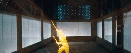 A Person Is Holding A Sword In A Room With A Lot Of Windows And Lights . GIF
