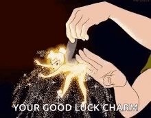 A Person Is Holding A Tinkerbell Figurine With A Knife And Saying `` Your Good Luck Charm '' . GIF