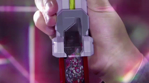 A Person Is Holding A Toy In Their Hand That Looks Like A Knife GIF