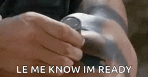 A Person Is Holding A Watch On Their Wrist And The Words `` Le Me Know Im Ready '' Are Visible . GIF
