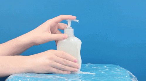 A Person Is Holding A White Bottle With A Hose Attached To It GIF