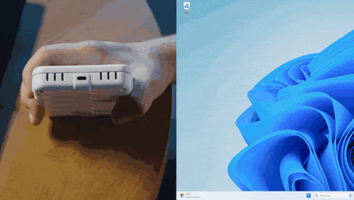 A Person Is Holding A White Device Next To A Blue Flower GIF