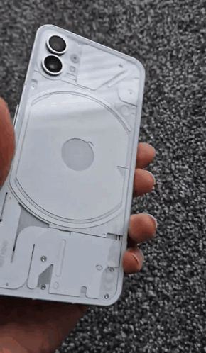 A Person Is Holding A White Iphone That Has The Back Removed GIF
