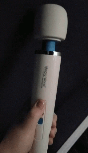 A Person Is Holding A White Magic Wand With A Blue Tip GIF