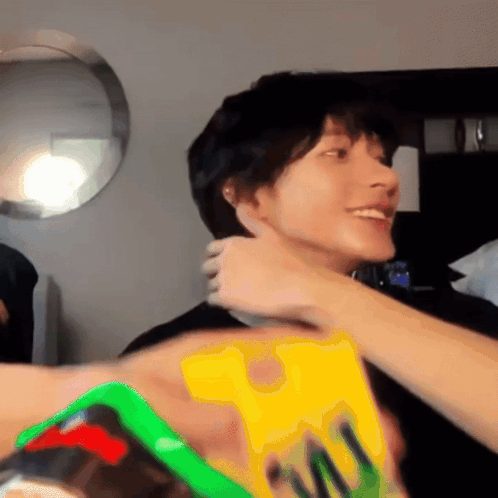 Person Holding Yellow M & M Item GIF