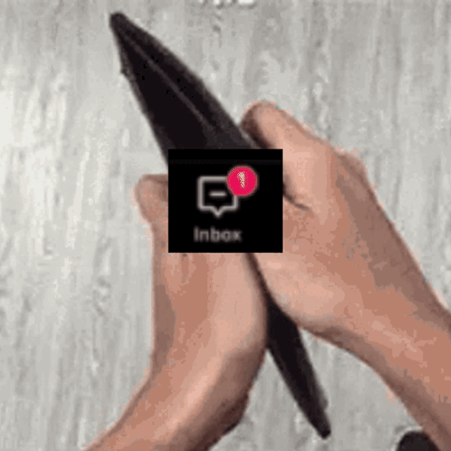 A Person Is Holding An Empty Wallet With An Inbox Notification On The Screen . GIF