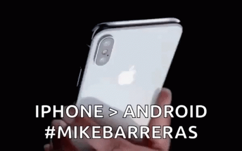 A Person Is Holding An Iphone In Their Hand With The Words Iphone > Android #Mikebarrieras Written On It . GIF