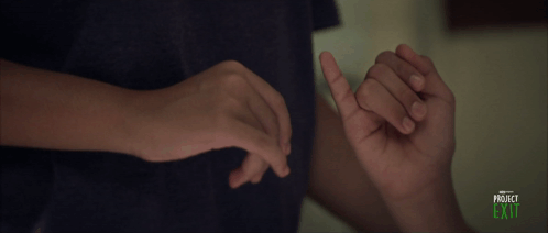 A Person Is Holding Another Person 'S Finger And The Words Project Exit Are On The Bottom GIF