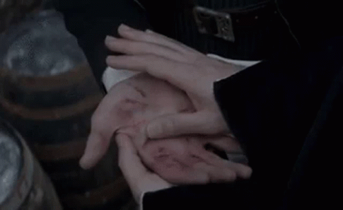 A Person Is Holding Another Person 'S Hand With A Wound In It . GIF