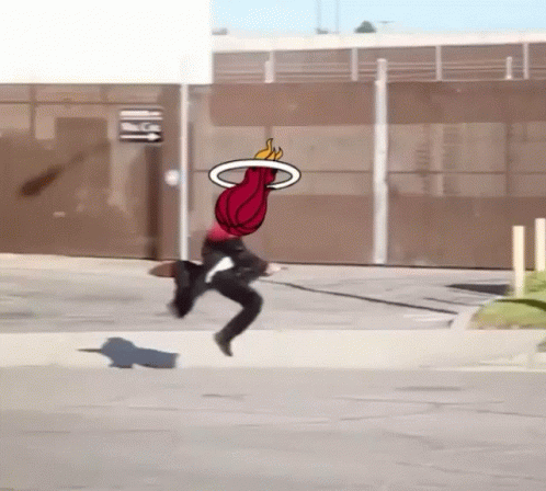 A Person Is Jumping In The Air With A Basketball In The Air GIF