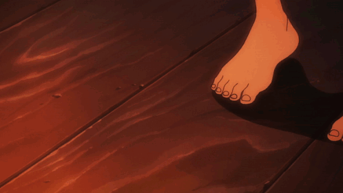 A Person Is Kneeling Down And Holding A Piece Of Wood GIF