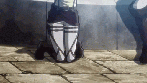 A Person Is Kneeling Down With Their Legs Crossed In Front Of A Wall With The Letters Sbs Visible GIF