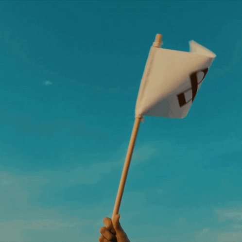 A Person Is Kneeling On The Beach Playing In The Sand GIF