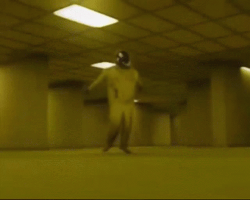 A Person Is Laying On The Floor In A Dark Room With A Yellow Ceiling . GIF