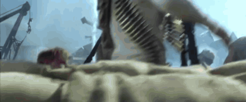 A Person Is Laying On The Ground With A Bullet Belt Around Their Waist GIF