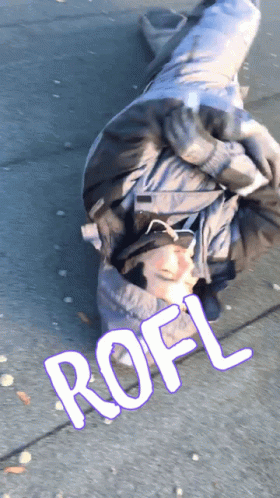 A Person Is Laying On The Ground With The Word Rofl Written On The Sidewalk GIF
