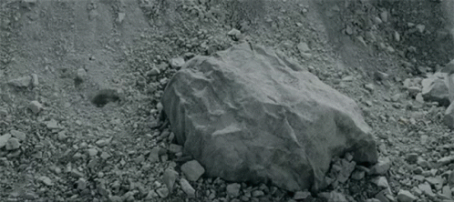 a person is laying on the ground with their head on another person 's knee .