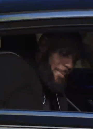 A Person Is Looking Out Of A Window Of A Car GIF