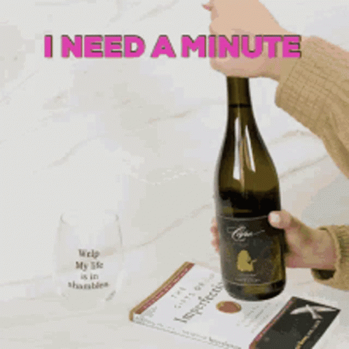 A Person Is Opening A Bottle Of Wine With The Words I Need A Minute Behind Them GIF