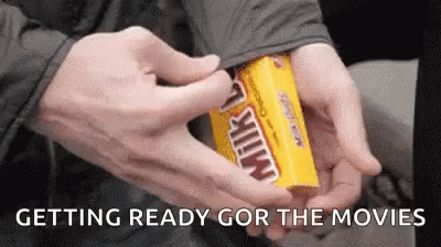 A Person Is Opening A Box Of Milky Way Candy GIF
