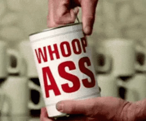 A Person Is Opening A Can Of Whoop Ass Soup . GIF