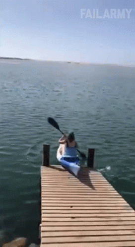 A Person Is Paddling A Kayak On A Dock And Failarmy Is Written On The Bottom GIF