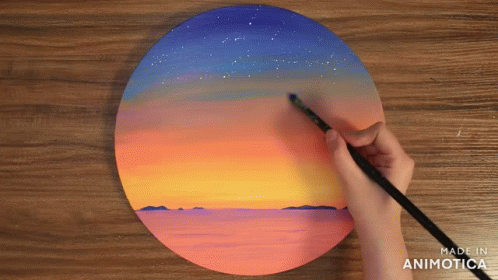 A Person Is Painting A Sunset On A Wooden Board With The Words Made In Animotica Below It GIF