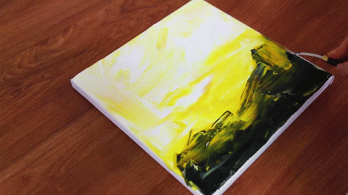 A Person Is Painting A Yellow And Black Painting On A Canvas GIF