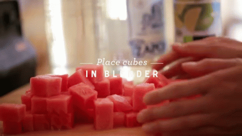 A Person Is Placing Cubes In A Blender With The Words Place Cubes In Blender Below Them GIF