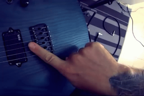 A Person Is Playing A Blue Guitar With A Pickup That Says Emg On It GIF