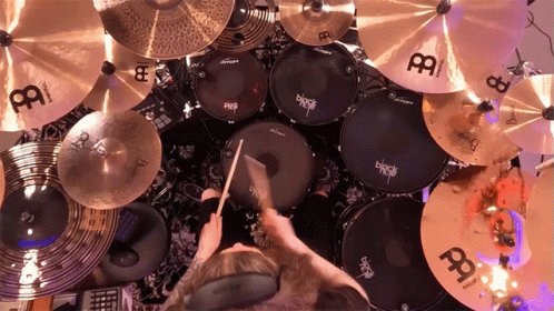 A Person Is Playing A Drum Set With A Cymbal That Says ' Black ' On It GIF