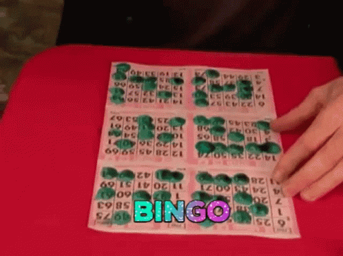 A Person Is Playing A Game Of Bingo On A Table GIF