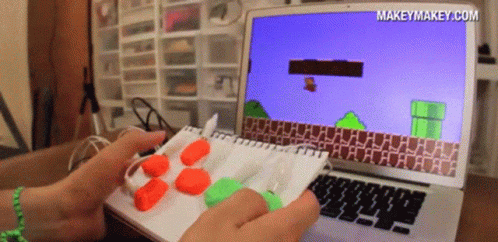 A Person Is Playing A Video Game On A Laptop With The Website Makeymakey.com Displayed On The Screen GIF